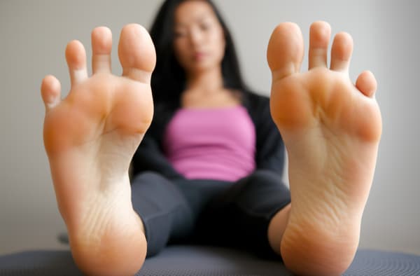 hippie girlfriend shoves both her big meaty soles together in your face, wrinkled scrunching soles, painted toenails, close up